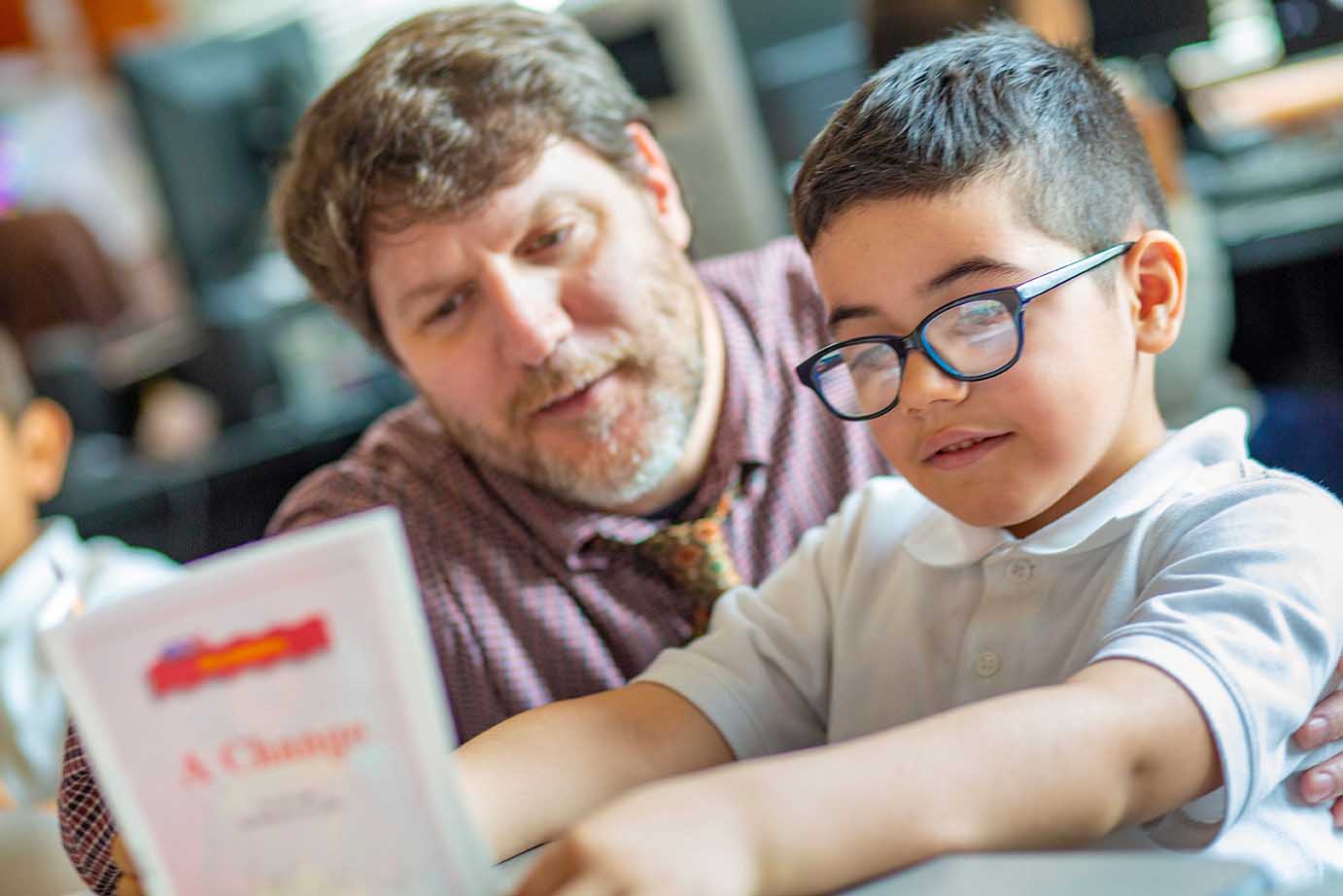  A man reading with a boy 